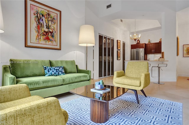 living room featuring an inviting chandelier and a high ceiling