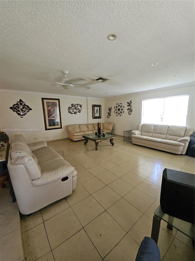 living room featuring light tile patterned flooring, ornamental molding, and a textured ceiling