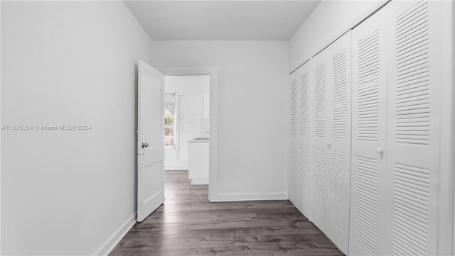 corridor featuring dark hardwood / wood-style floors