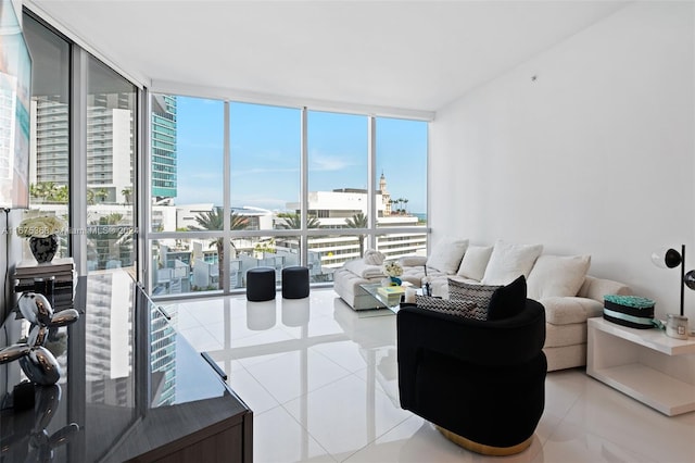 living room with expansive windows and tile patterned flooring