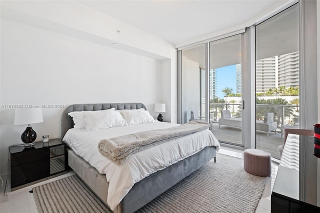 tiled bedroom featuring access to outside and a wall of windows