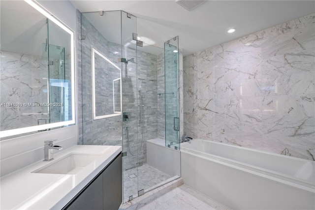 bathroom featuring vanity and separate shower and tub