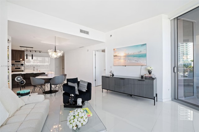 living room featuring an inviting chandelier and light tile patterned floors