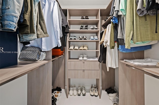 spacious closet featuring light tile patterned flooring