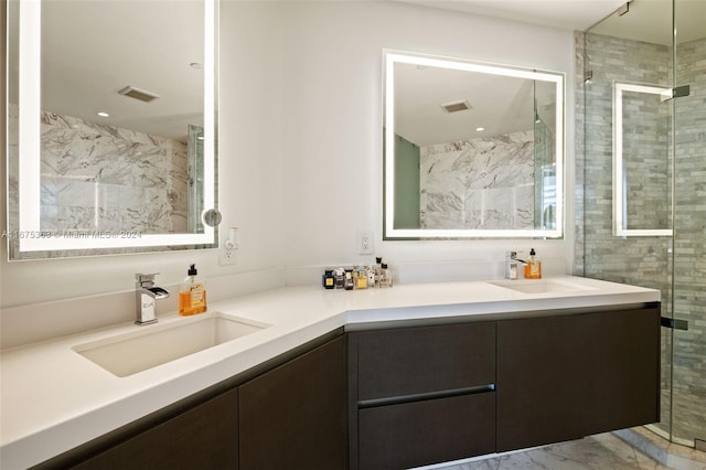 bathroom with vanity and a shower with shower door