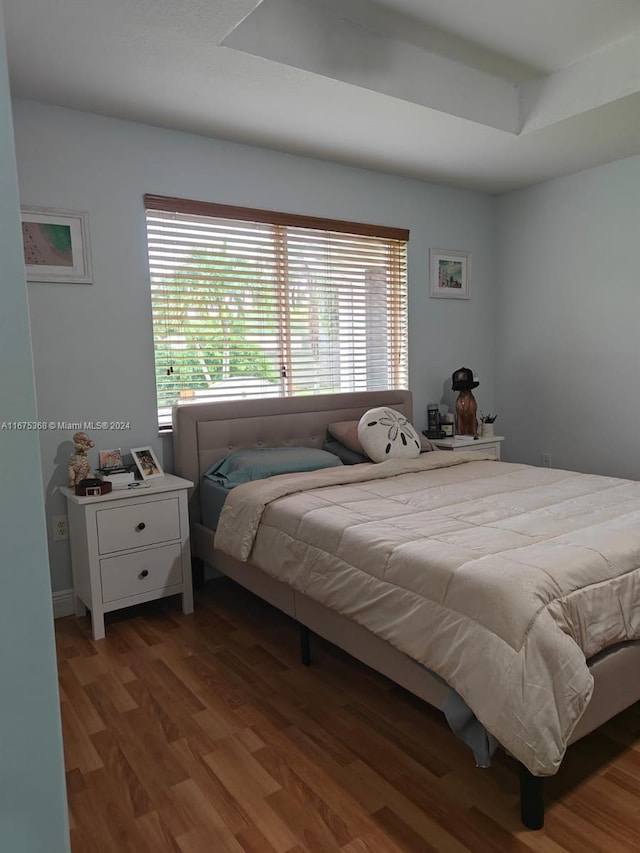 bedroom featuring wood-type flooring and multiple windows