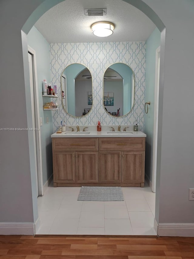 bathroom featuring vanity, a textured ceiling, and hardwood / wood-style flooring