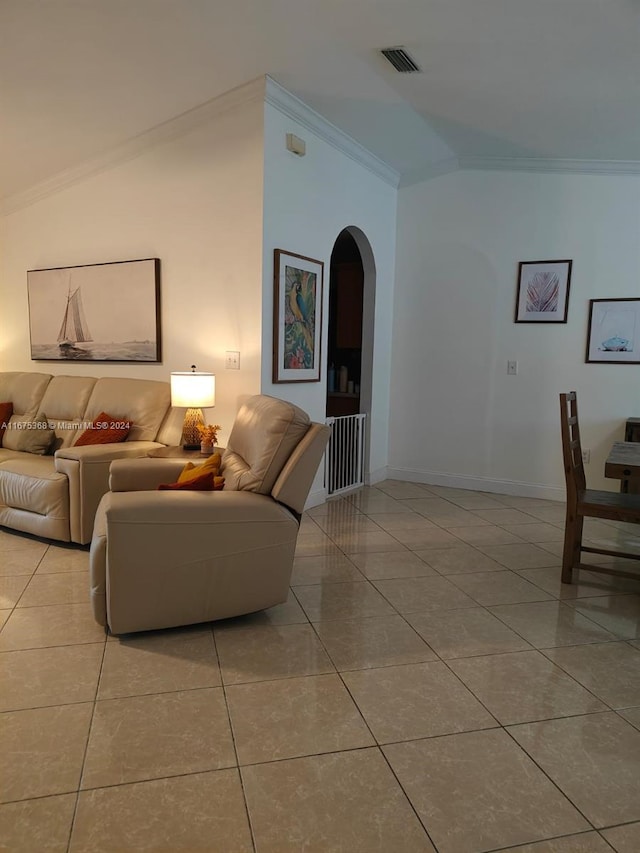 tiled living room with ornamental molding and vaulted ceiling