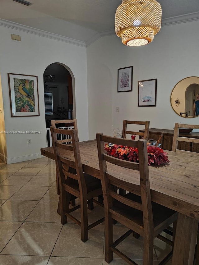 dining area featuring light tile patterned flooring and ornamental molding