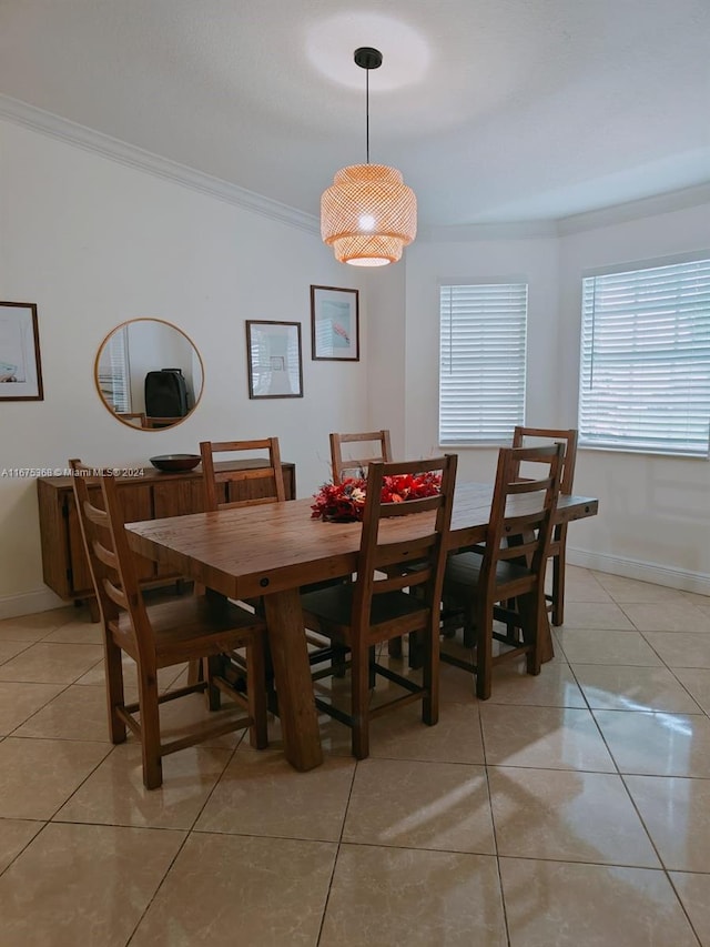 tiled dining room featuring ornamental molding