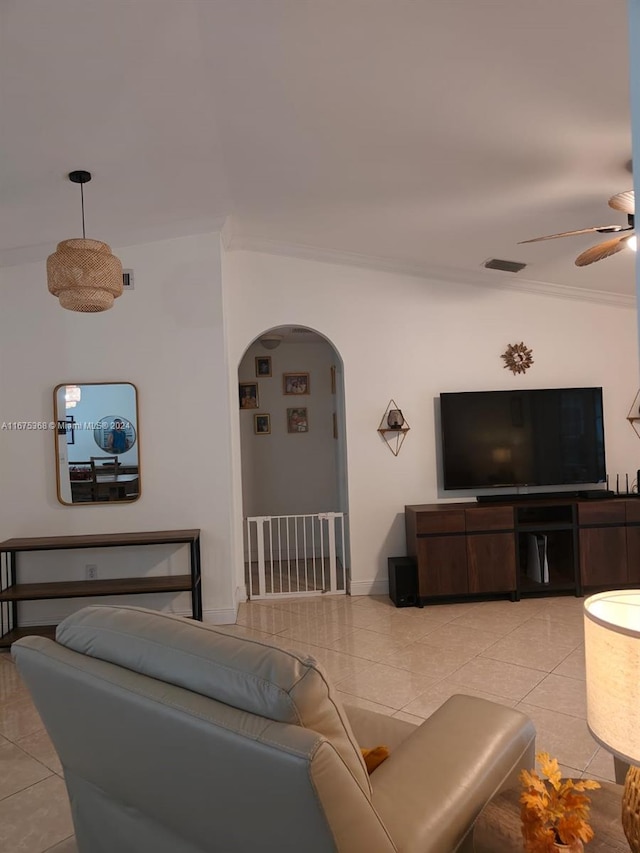 tiled living room featuring crown molding, ceiling fan, and vaulted ceiling