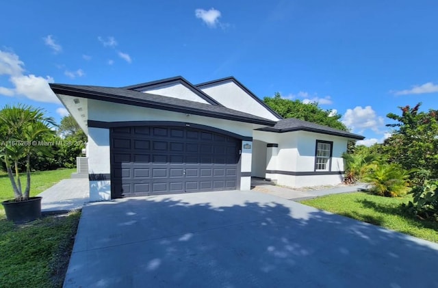 view of front facade with a front yard and a garage