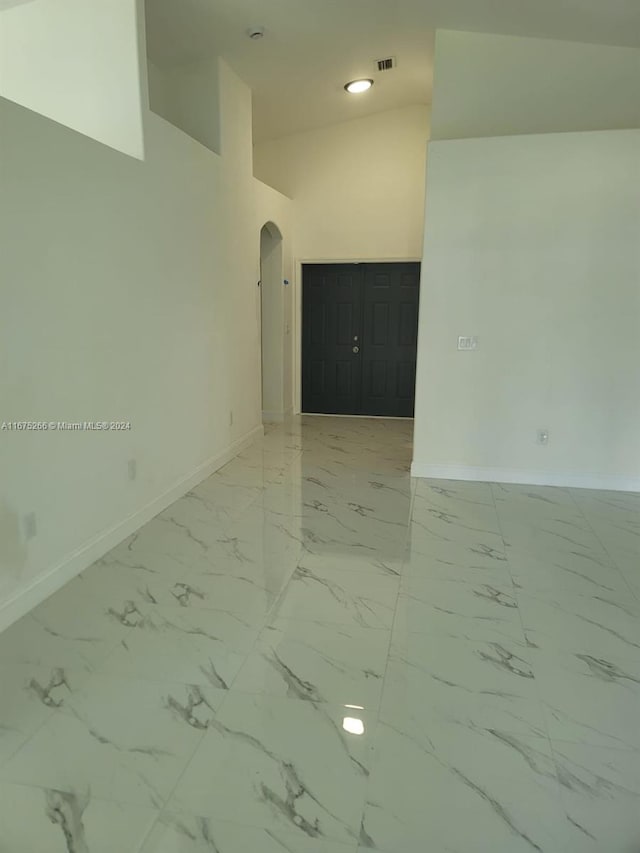 spare room featuring high vaulted ceiling