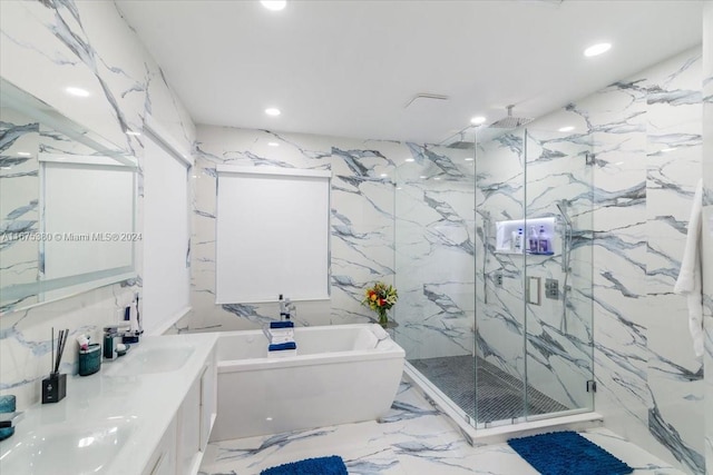 bathroom with shower with separate bathtub, vanity, and tile walls