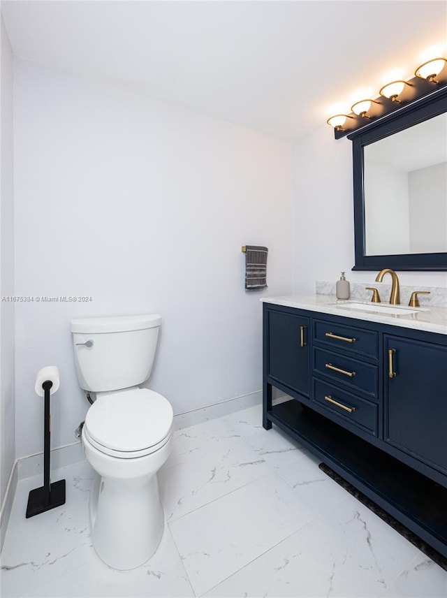 600 Three Islands Blvd Unit 214, Hallandale Beach, FL 33009 - bathroom with marble look tile flooring, toilet, baseboards, and vanity