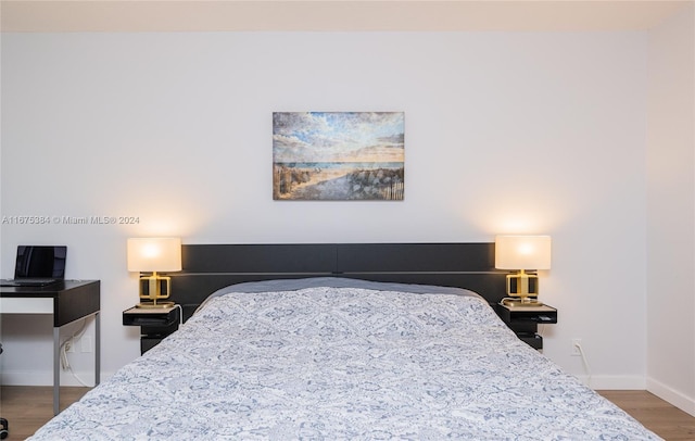 600 Three Islands Blvd Unit 214, Hallandale Beach, FL 33009 - bedroom featuring wood finished floors and baseboards