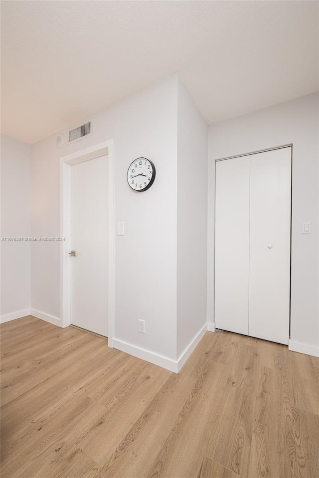 600 Three Islands Blvd Unit 214, Hallandale Beach, FL 33009 - unfurnished bedroom with baseboards and light wood-style flooring
