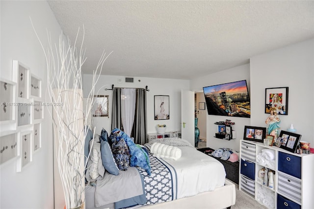 bedroom with carpet floors and a textured ceiling