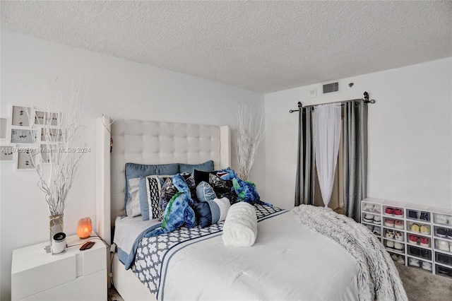 carpeted bedroom with a textured ceiling