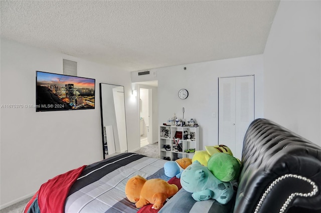 carpeted bedroom featuring a textured ceiling and a closet