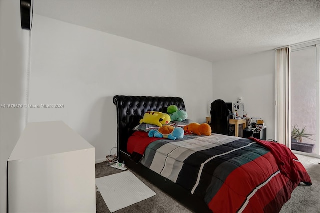 bedroom featuring carpet floors and a textured ceiling