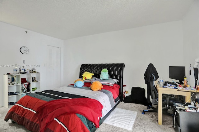 bedroom featuring carpet floors and a textured ceiling