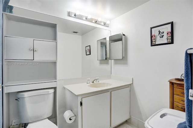 bathroom featuring vanity and toilet