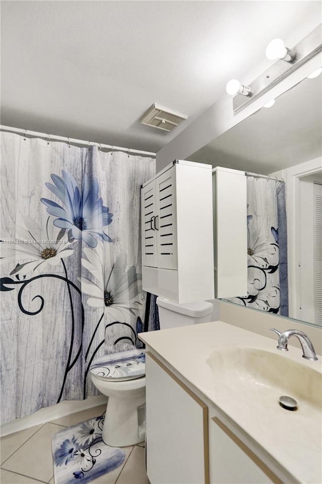 bathroom with tile patterned floors, a shower with shower curtain, vanity, and toilet