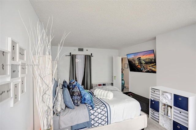 bedroom featuring carpet and a textured ceiling