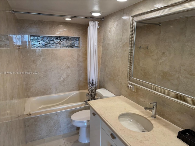 full bathroom featuring shower / tub combo with curtain, vanity, tile walls, tile patterned floors, and toilet