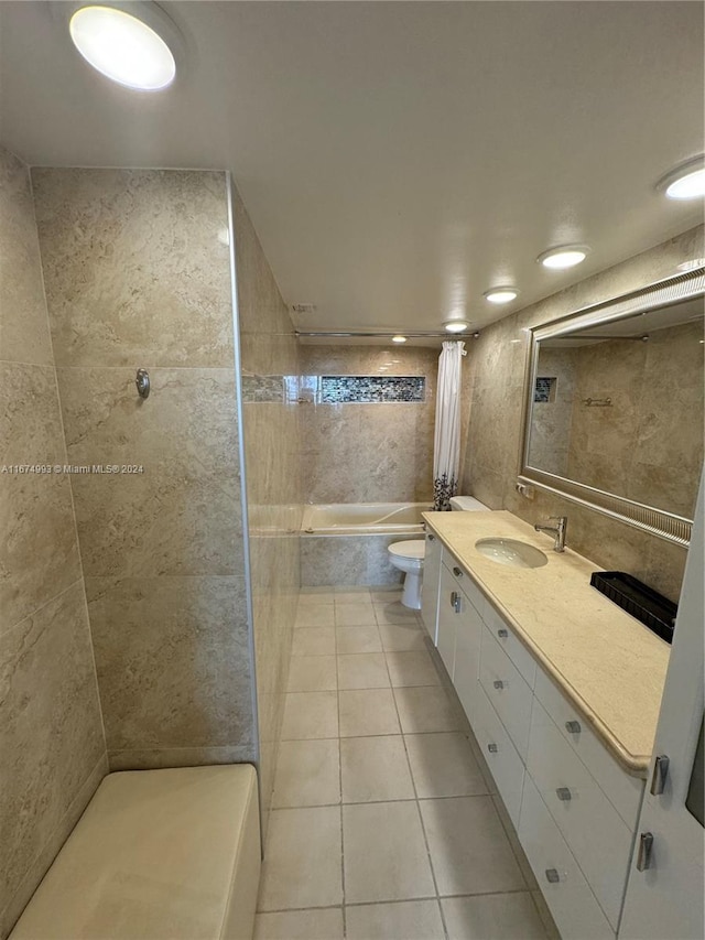 full bathroom featuring shower / bath combination with curtain, vanity, tile patterned floors, tile walls, and toilet