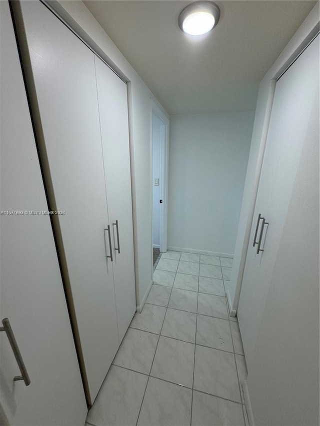 hall featuring light tile patterned floors