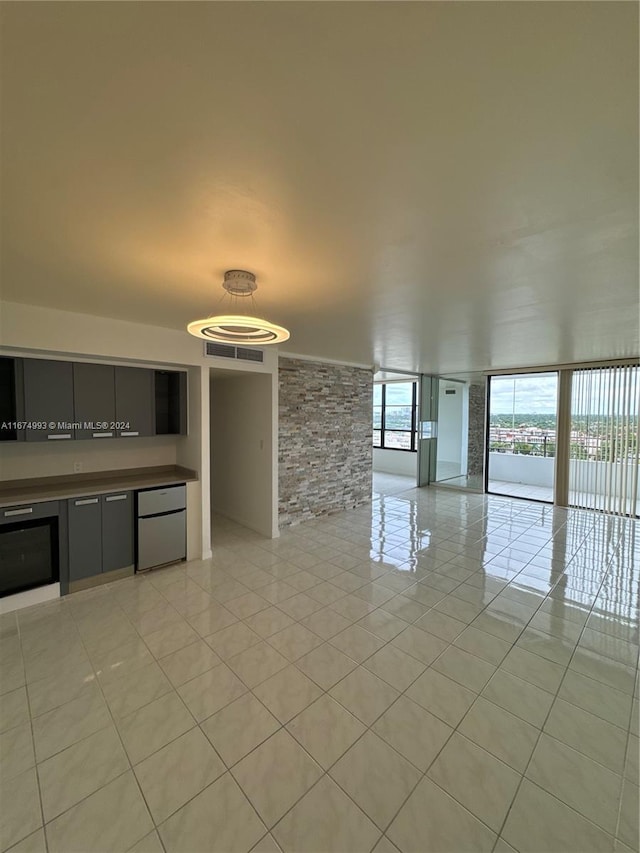 unfurnished living room with light tile patterned floors