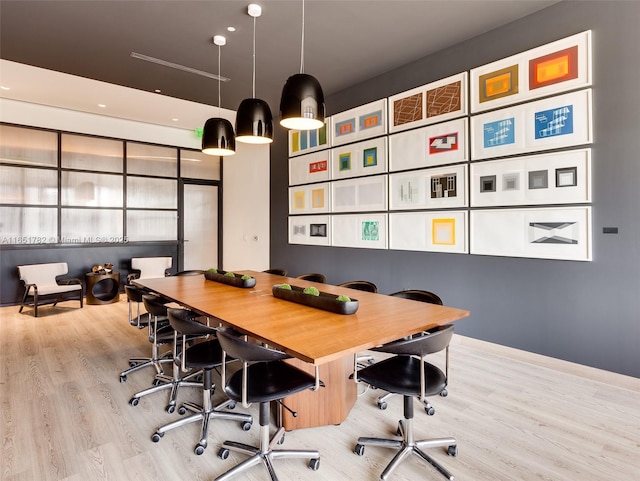 home office with light hardwood / wood-style flooring