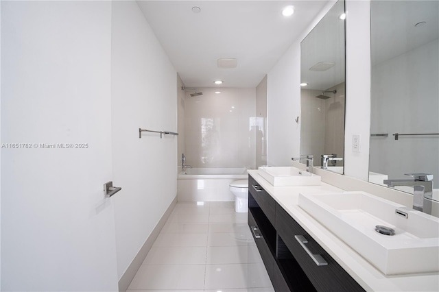 full bathroom with tiled shower / bath, tile patterned floors, toilet, and vanity