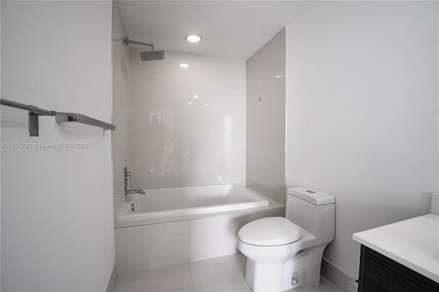 full bathroom featuring vanity, toilet, tiled shower / bath combo, and tile patterned flooring