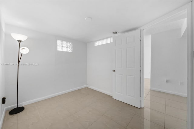 basement featuring light tile patterned floors