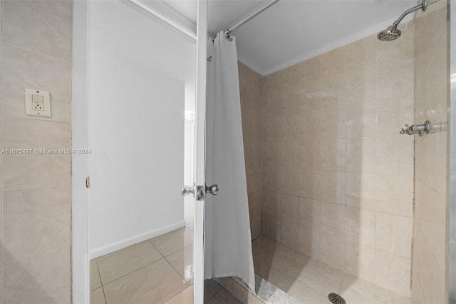 bathroom featuring a shower with curtain, tile patterned flooring, and ornamental molding