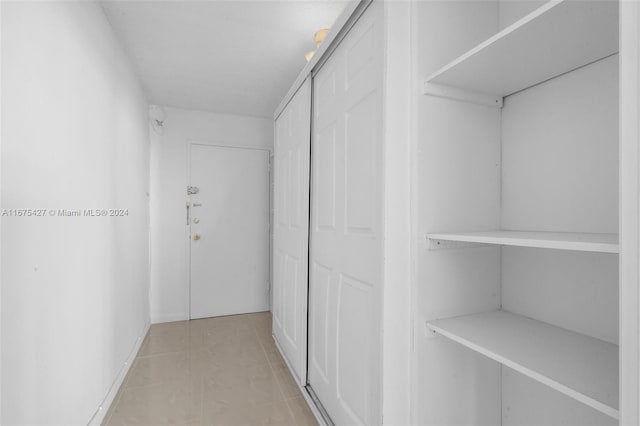 spacious closet featuring light tile patterned flooring