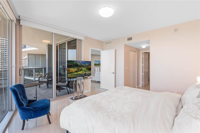 tiled bedroom featuring a wall of windows and access to exterior