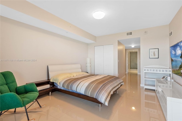 tiled bedroom with a closet