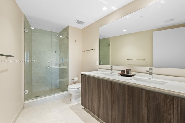 bathroom featuring tile patterned flooring, walk in shower, vanity, and toilet