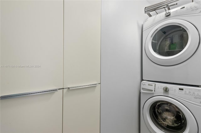 laundry room featuring stacked washing maching and dryer