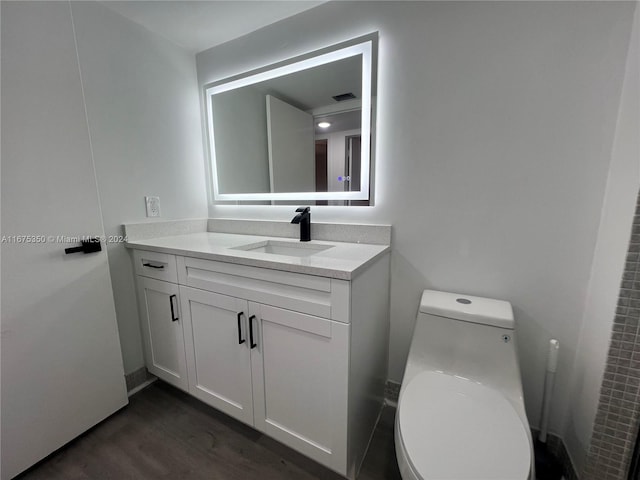 bathroom featuring vanity, toilet, and wood-type flooring