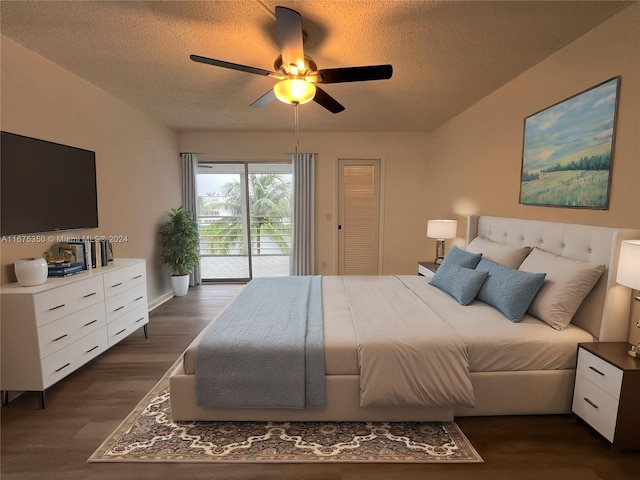 bedroom featuring ceiling fan, a textured ceiling, dark hardwood / wood-style floors, and access to exterior