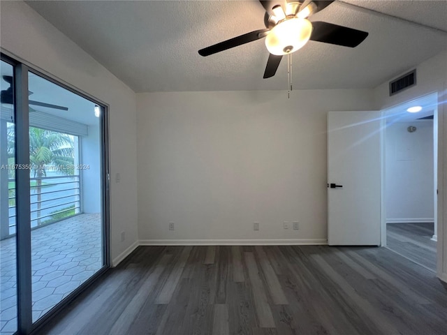 spare room with dark wood-type flooring, a textured ceiling, and ceiling fan