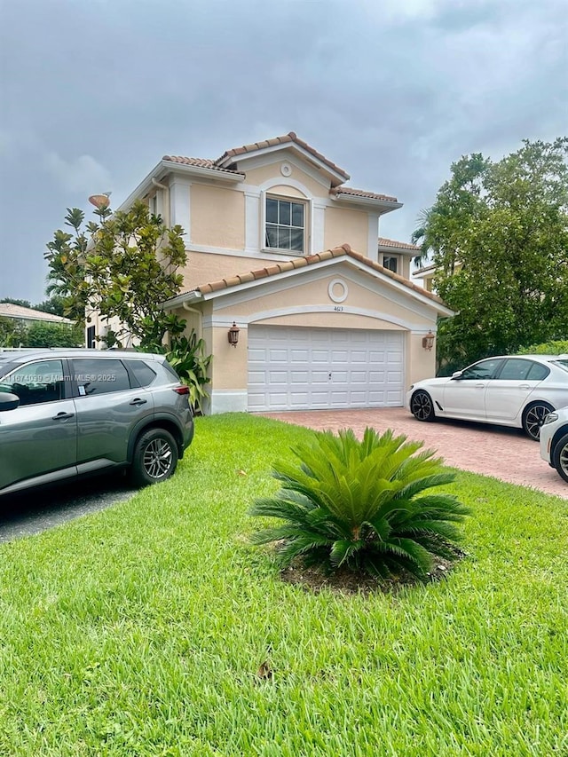 view of front of home featuring a front lawn and a garage