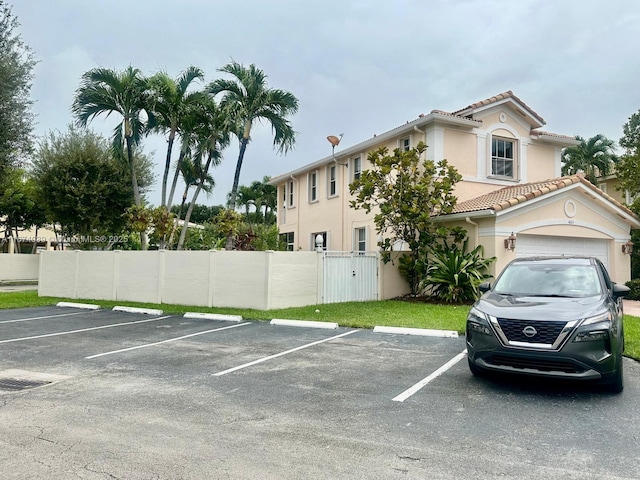 view of parking / parking lot featuring a garage