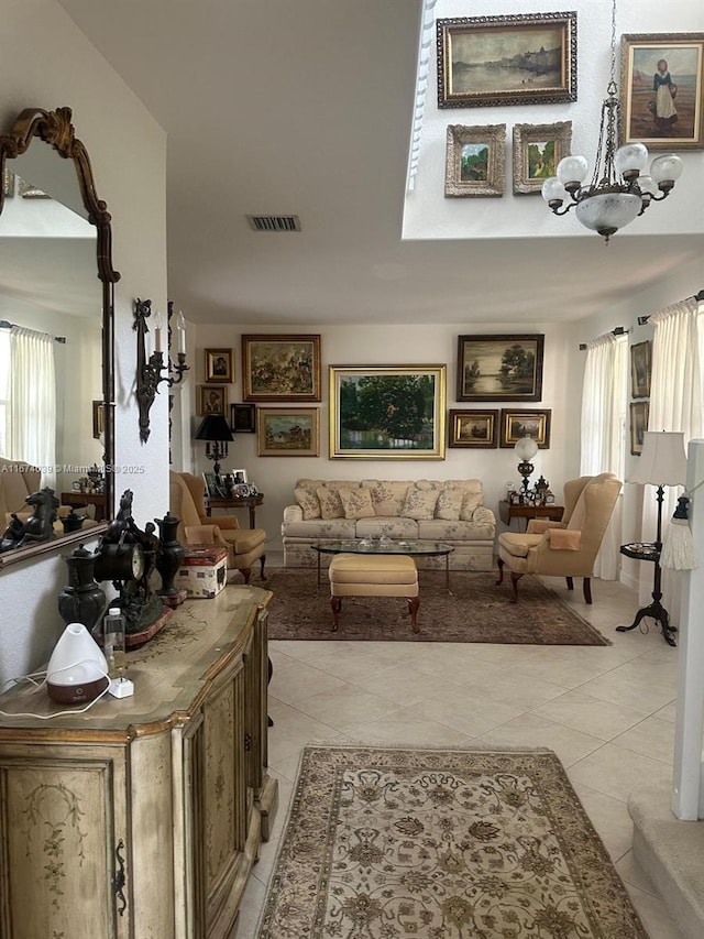 living room with light tile patterned flooring and a chandelier