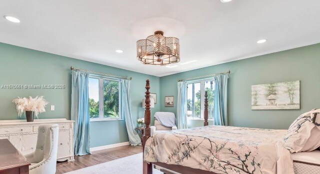 bedroom with hardwood / wood-style flooring and ceiling fan